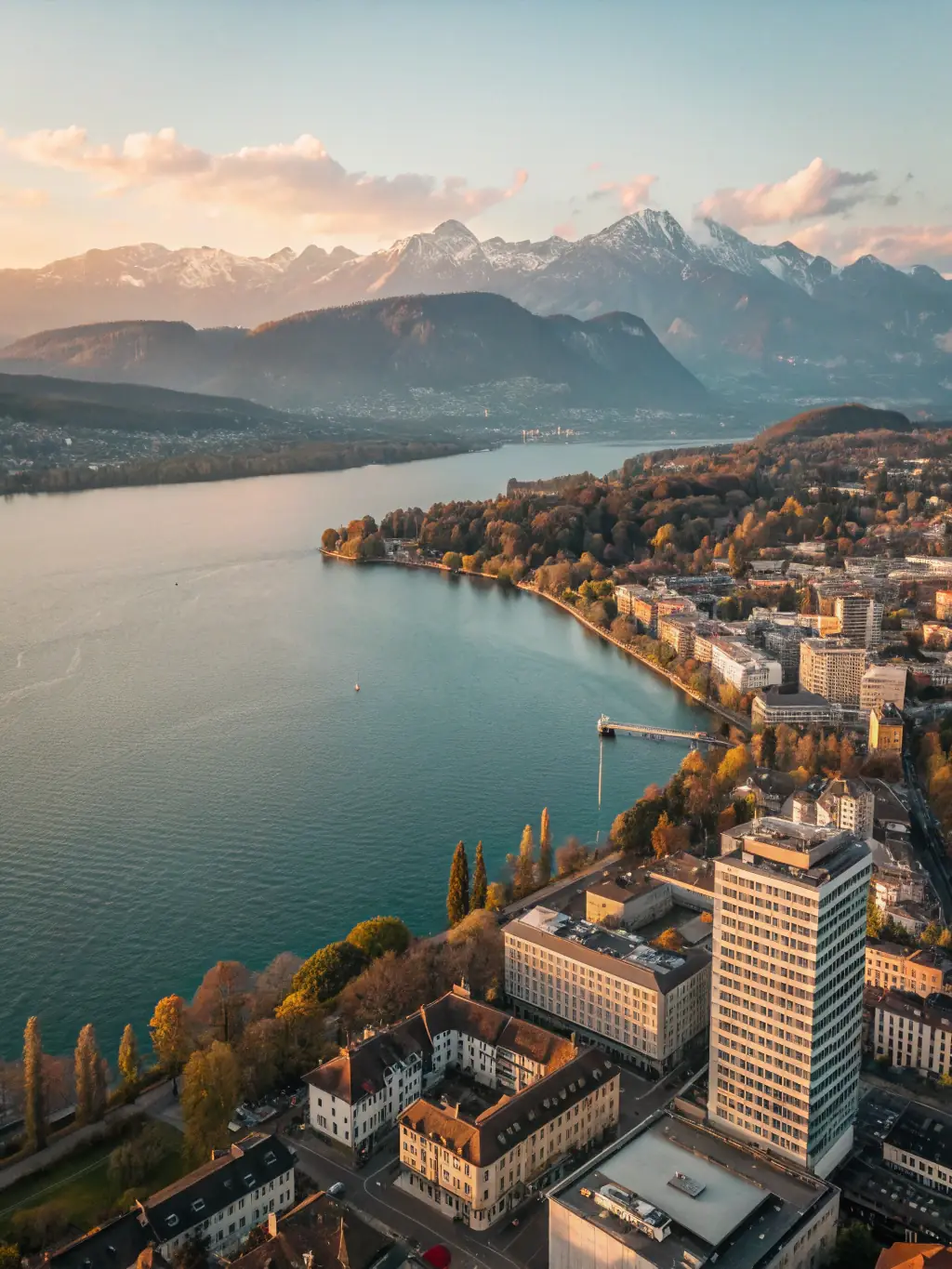 A sophisticated, high-angle shot of a Zurich cityscape at dusk, emphasizing the financial district with modern architecture and subtle gold lighting reflecting off the glass buildings, symbolizing Lexum House of Law's strategic counsel in global markets.